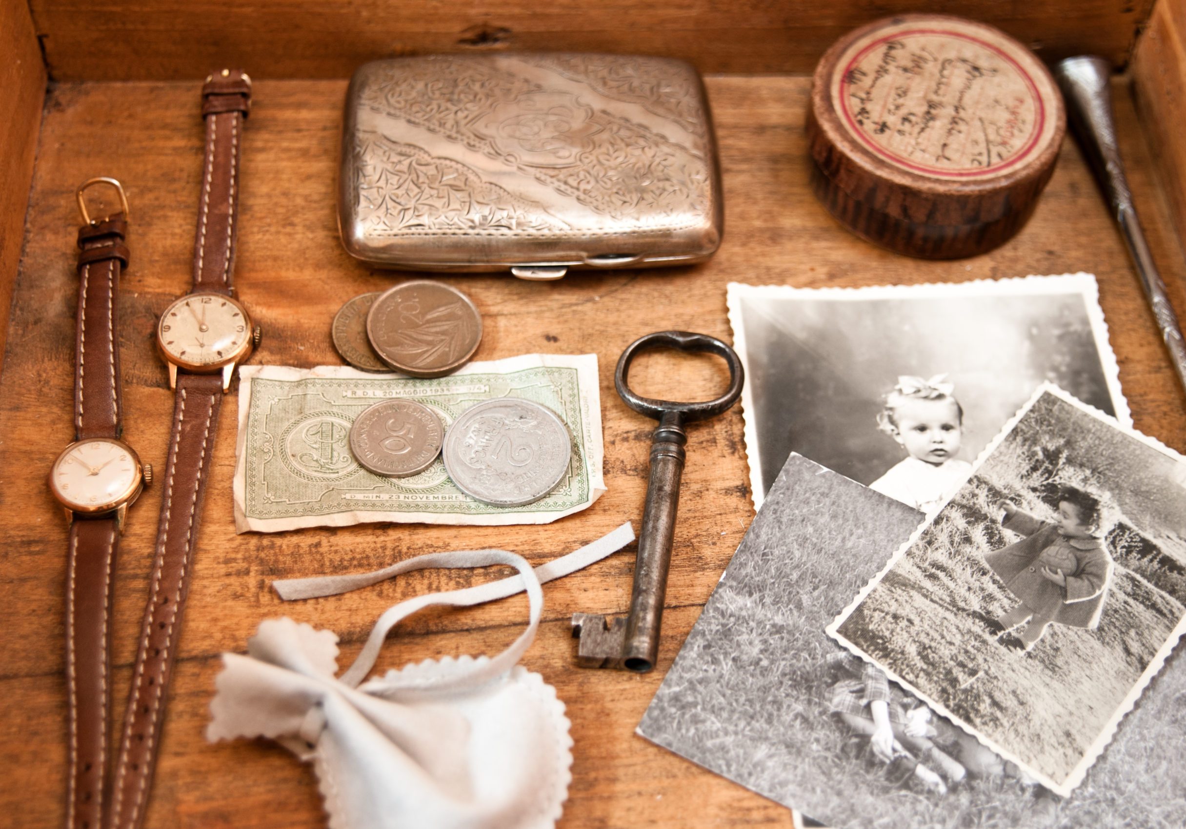 Wooden drawer full of old objects and photos
